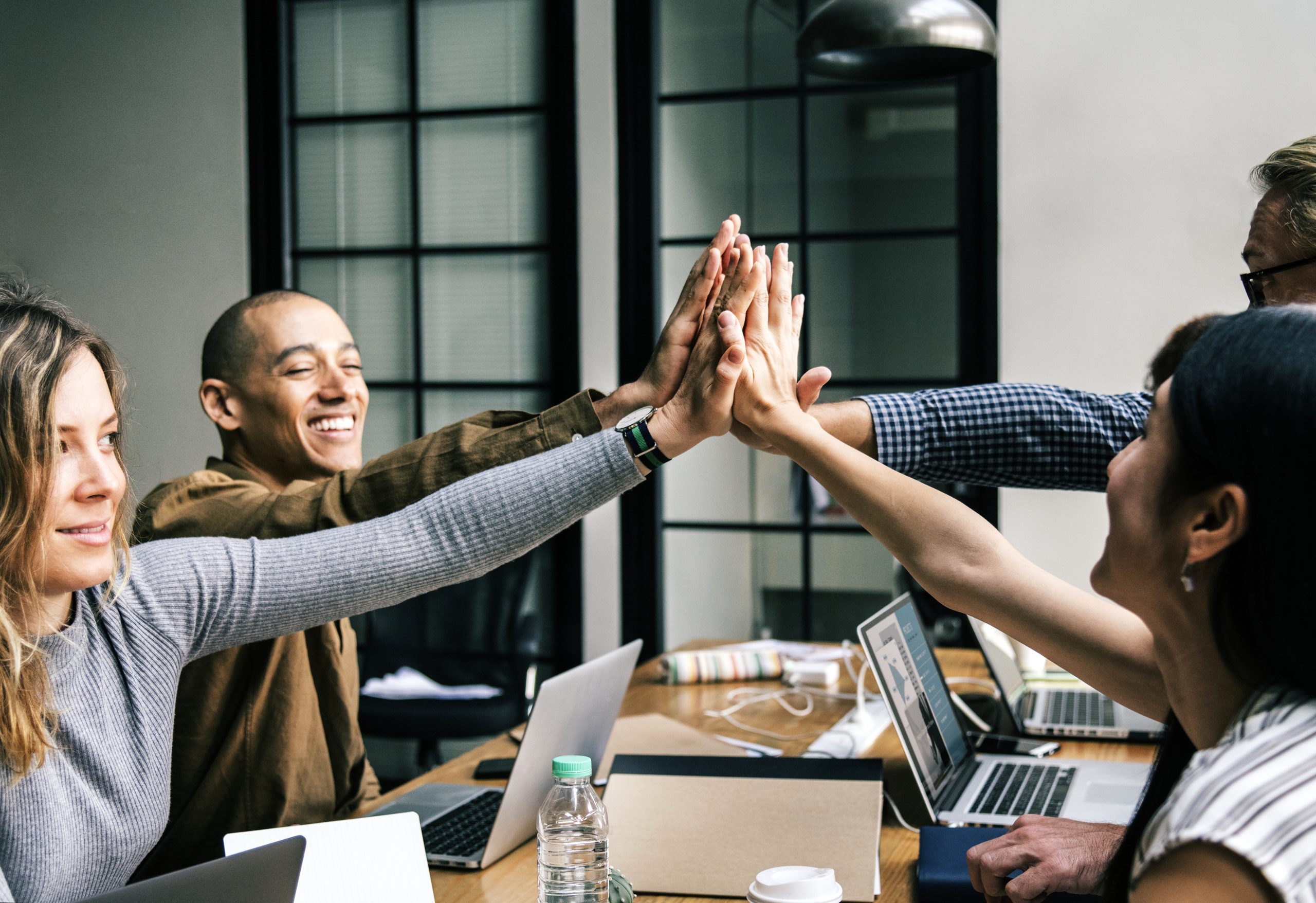 RemarkablePeople team hands together